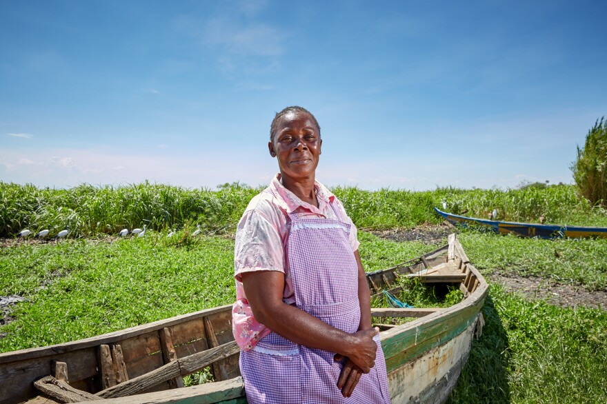 Alice Amonde sits on a boat on the village of Nduru Beach, Kenya. She is part of the group of women who have fought against the practice of transactional sex that was part of the fishing business. This photograph was taken in November 2019. This spring, flooding from Lake Victoria devastated the village.