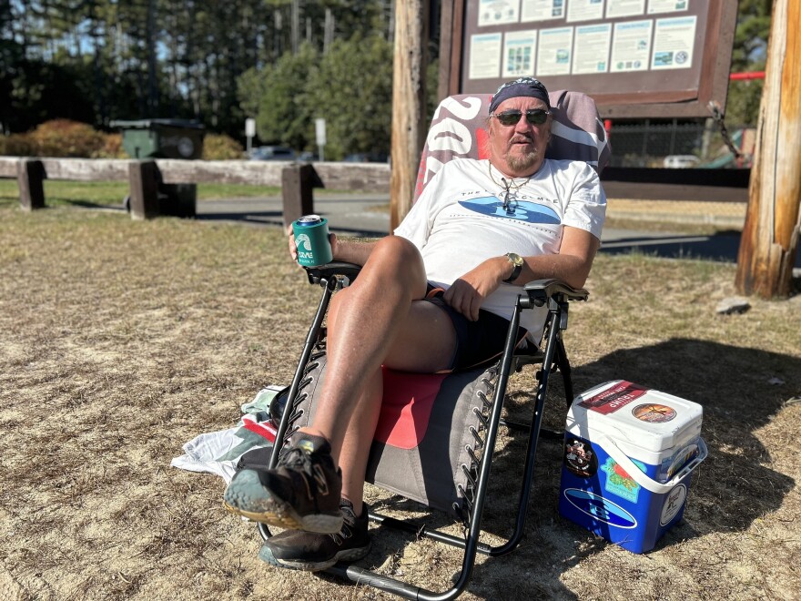 Gary Chaisson relaxed on the sand at Crystal Lake in Manchester on Sunday. “I couldn’t believe it when I came down here,” he said. “What a day. But it’s better than being cold, I guess.”