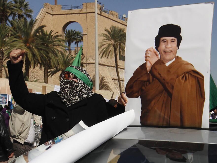 A supporter of Libyan leader Moammar Gadhafi took part in a pro-government rally Thursday in Tripoli.