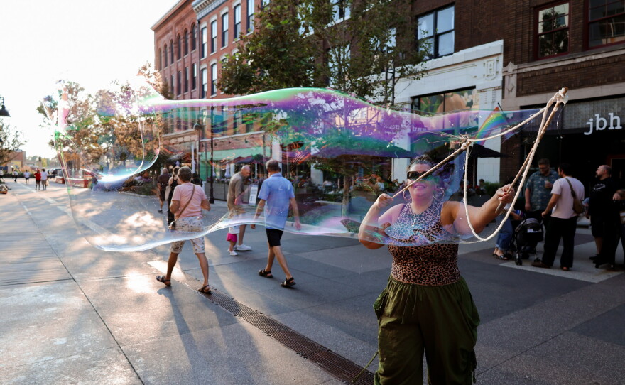Community members enjoy a fun evening with giant bubbles at the Landing.