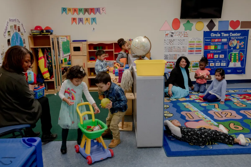 Three and four-year-old students play while Michelle James, left, executive director of community action agency of western Connecticut, and Mini Santosh, child care director at Action Early Learning Center in Danbury, watch. "We bring people in, and we lose them," Sanotosh said of her staff. "They would hate to stay in industry, go to school, and then they're looking at what does my check look like five years from now? Not change."