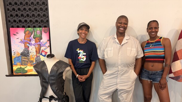 From left to right, mars patterson, Destiny Brady, and Fatima Laster pose around artwork that is part of the "This Is America Exibition.