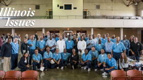 Students, teachers, staff and volunteers posed for a picture after a convocation ceremony for the fall semester of a masters degree program at Stateville Correctional Center.