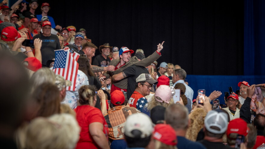 Security staff escort a heckler out of President Donald Trump's midterm rally for Republicans in Daytona Beach on Friday, Oct. 30, 2026.