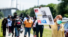People return to their vehicles after gathering to honor the life of Ahmaud Arbery at Sidney Lanier Park on May 9 in Brunswick, Ga. Arbery was shot and killed while jogging in the nearby Satilla Shores neighborhood on Feb. 23.