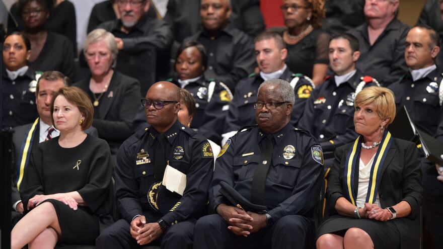 Dallas Police Chief David Brown (second from left) and Dallas Area Rapid Transit Police Chief James Spiller (second from right) attend an interfaith memorial service for the victims of the Dallas police shooting.