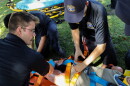 Cameron Loureiro, left, puts spider straps on a dummy patient who has lost limbs during an emergency call scenario.