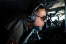U.S. Air Force Tech. Sgt. Tyler Simmons in an airplane with headset and sunglasses on.