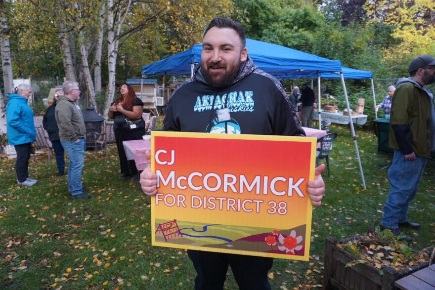 Rep. Conrad "CJ" McCormick, D-Bethel, holds a campaign sign at a Sept. 18 fundraiser held at the Midtown Anchorage home of Rep. Alyse Galvin, I-Anchorage. McCormick is seeking reelection after his freshman term.