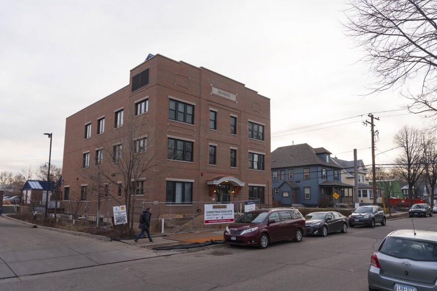 The Sundial is located between neighborhood houses and a larger mixed-use building along Nicollet Avenue.