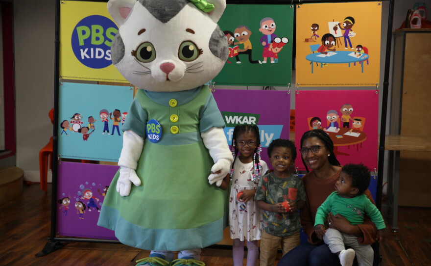 Visitors pose with Katerina Kittycat at Be My Neighbor Day with WKAR.