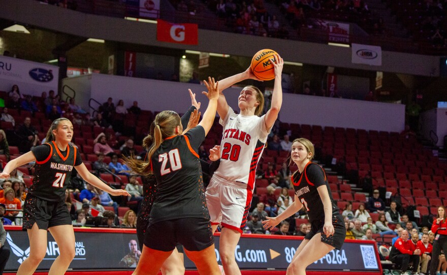 Girls high school basketball players inside an arena