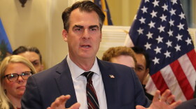Oklahoma Governor Kevin Stitt speaks in support of a grocery tax cut at a bill signing ceremony Feb. 27, 2024, in a ceremonial room inside the Oklahoma State Capitol.