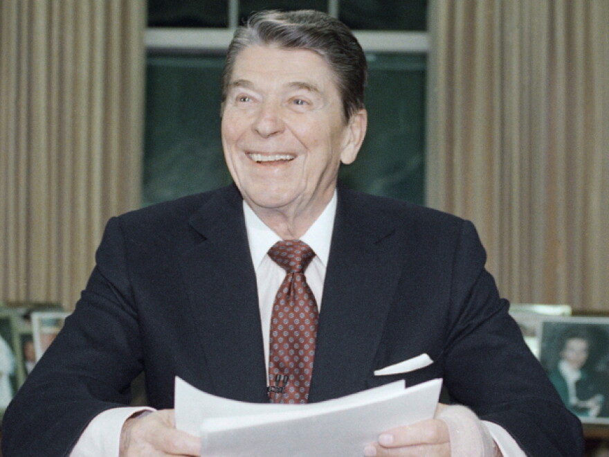 President Ronald Reagan poses for photographers in the Oval Office of the White House, Jan. 11, 1989 after delivering a televised farewell address to the nation. In the parting address, Reagan said that during his eight years in office, "we meant to change a nation and instead we changed a world."