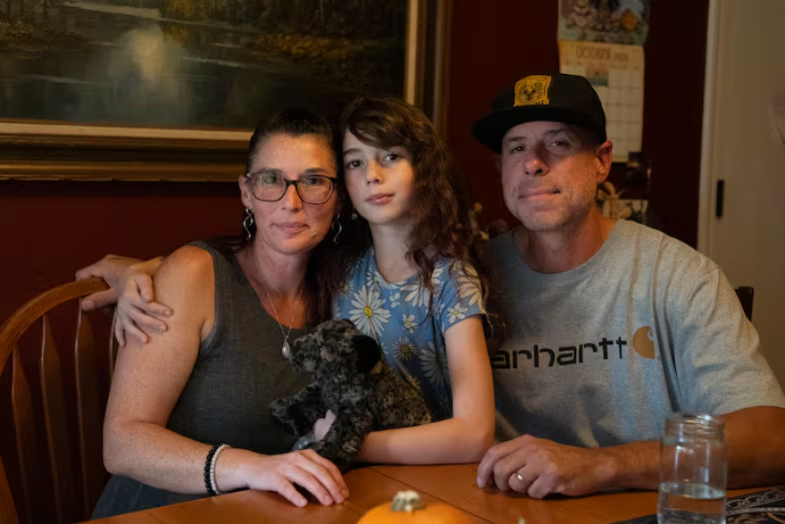 From left to right, Kristan Banks, Phoenix Banks and Damien Banks pose for a portrait in their dining room in Bend, Ore., on Oct. 20, 2026. 