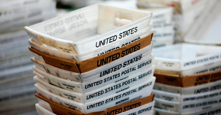 In this 2017 file photo, boxes for sorted mail are stacked at the main post office in Omaha, Neb.