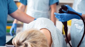 Patient and doctor in a hospital during colonoscopy, closeup