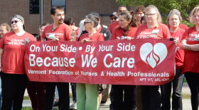 Union members at UVM Medical Center hold a banner during an AFT-VT union press conference 