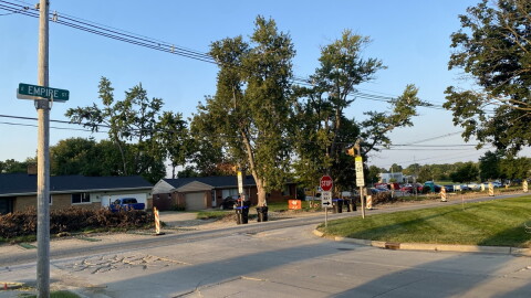 Landscape of Empire Street with construction cones along the roadside. Bloomington High School can be seen in the distance.