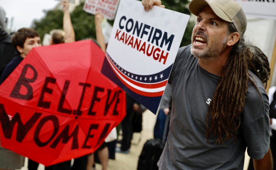 As the hearing goes on inside, a Kavanaugh supporter gets into an exchange of words with protesters.