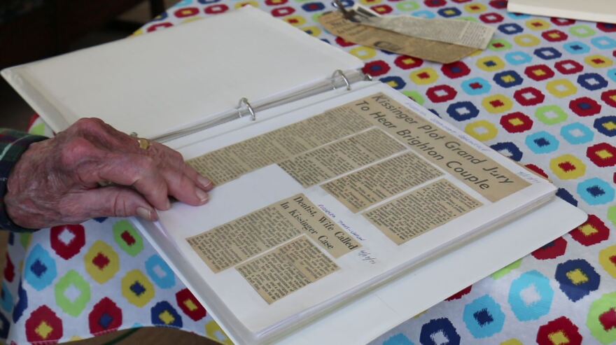 McVey looks through a scrapbook that has newspaper clippings detailing anti-war activities he was involved in.