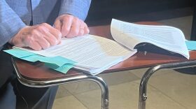 Rep. Ed DeLaney parses through a portion of the 127-page IEDC audit before reporters on Oct. 3, 2025.