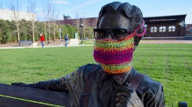 A statue of Orville Redenbacher in downtown Valparaiso with a knit mask over its face.