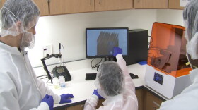 Gumennik's students look at testing swabs to be printed at their lab.