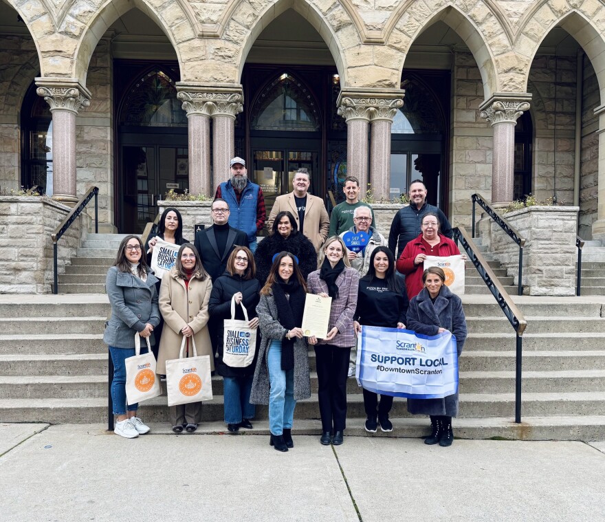 Ahead of Small Business Saturday, representatives from Scranton Tomorrow and the City of Scranton celebrate the kick off the holiday shopping season and the nonprofit's Deck the Downtown initiative outside Scranton City Hall.