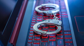 Handcuffs on the laptop,cyber concept