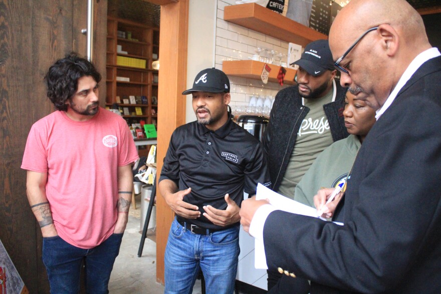 Partner Tulsa Senior Vice President of Development Jonathan Butler, center, speaks to Kirkpatrick Heights and Greenwood residents at an open house for the neighborhood's master plan on Saturday, Dec. 10, 2022, at Fulton Street Coffee and Books.