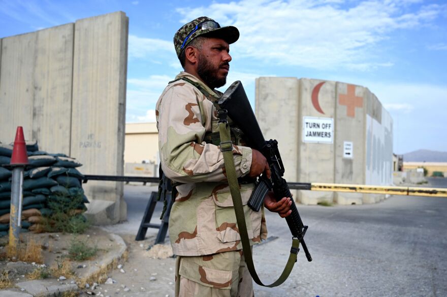 An Afghan National Army soldier stands guard at a gate of a hospital inside the Bagram Airbase after all U.S. troops left.