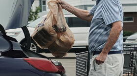 A person loads groceries in plastic bags into their vehicle, May 18, 2026, at a grocery store in Cincinnati. (Joshua A. Bickel/AP)