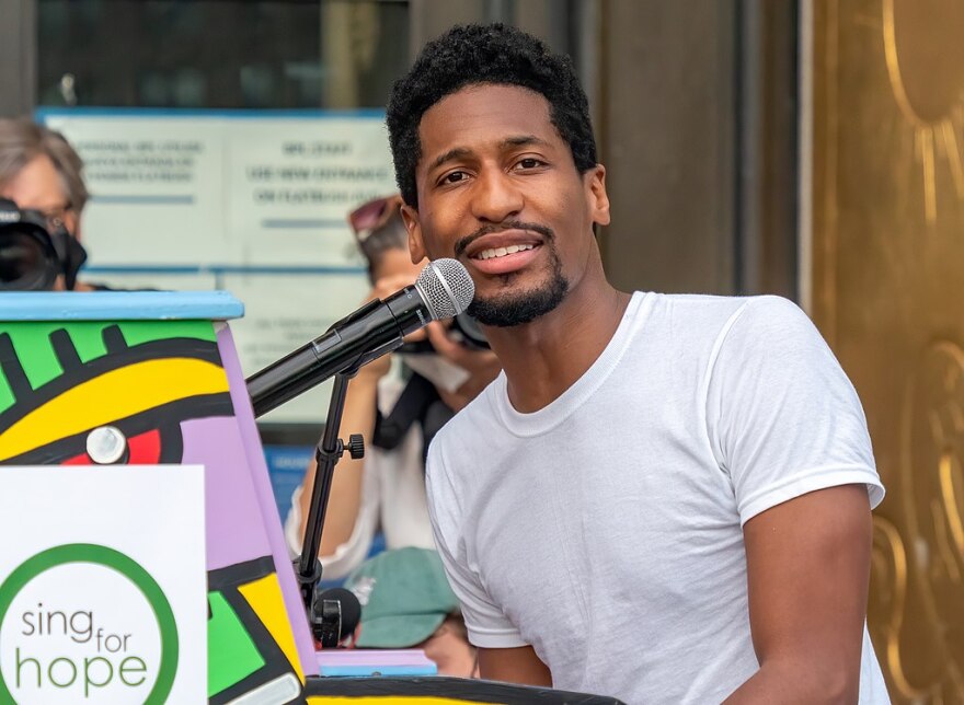 Musician Jon Batiste playing piano for a "Juneteenth celebration + voter registration recital" called "We Are" on June 19, 2020. On the steps of the Brooklyn Public Library in Grand Army Plaza.