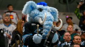 Utah Mammoth mascot Tusky bangs the drum during the third period of an NHL hockey game against the Colorado Avalanche, Tuesday, Oct. 21, 2025, in Salt Lake City, Utah.