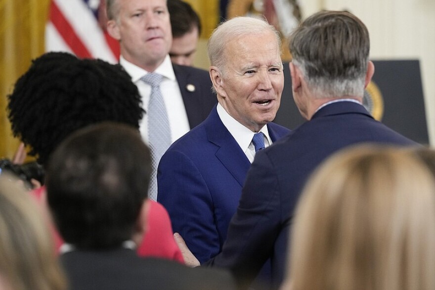 President Joe Biden greets Rep. John Hickenlooper, D-Colo., after Biden spoke during an event in the East Room of the White House in Washington, Thursday, March 23, 2023, celebrating the 13th anniversary of the Affordable Care Act.