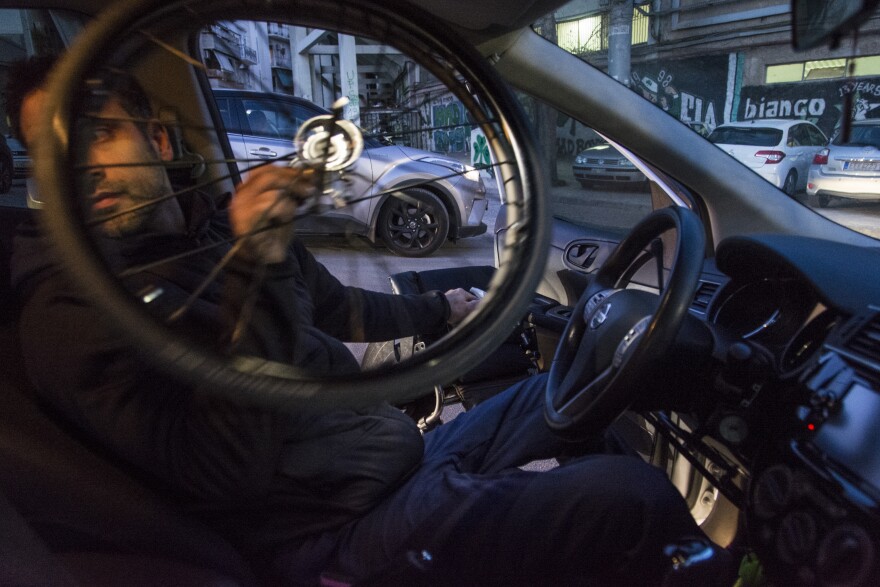 Triantafyllou disassembles his wheelchair to fit it on the back seat of his car.