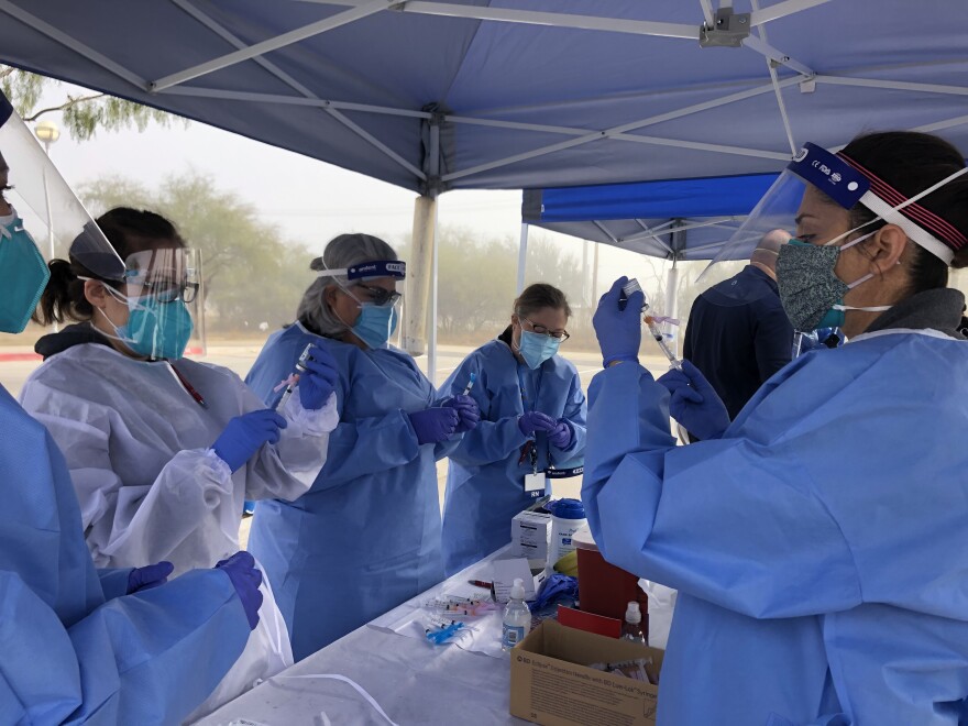 Nurses prepare doses of Moderna's COVID-19 vaccine for Laredo's vaccine drive. Vaccines were made available to health care workers, the elderly and adults with underlying conditions.