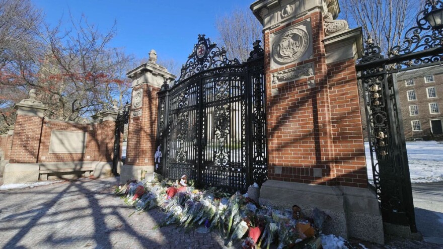 Flowers laid by mourners rest at a memorial on the Brown University campus for the victims of Saturday’s mass shooting.