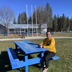 Danny Brigman sitting outside at the Wellpinit Powwow Grounds.