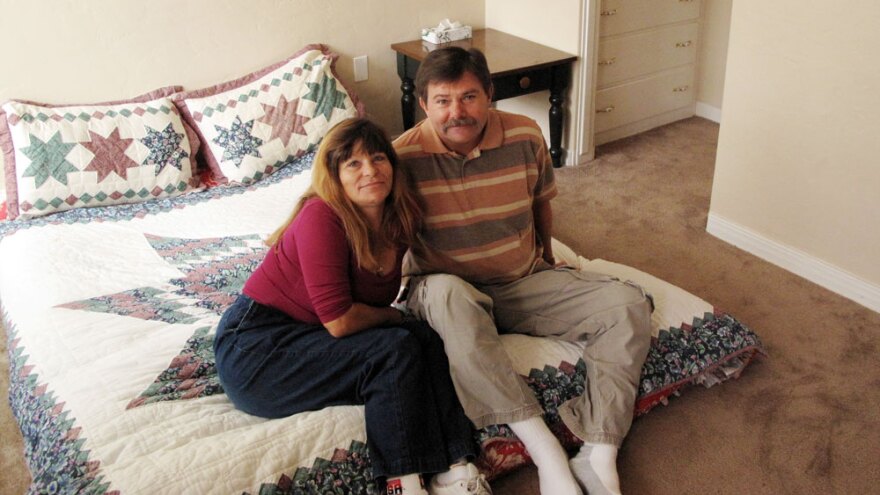 Philip Doud and  his girlfriend, Cathy Espong, sit in their new one-bedroom apartment.  They both lost their jobs and were found living on a San Diego sidewalk  during a survey of the city's homeless population last fall. The  Department of Veterans Affairs helped move the couple into permanent  housing as part of a campaign to end homelessness.