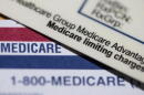 A Medicare Advantage PPO card rests on top of a Medicare card in Portland, Ore., June 10, 2024. (Jenny Kane/AP)