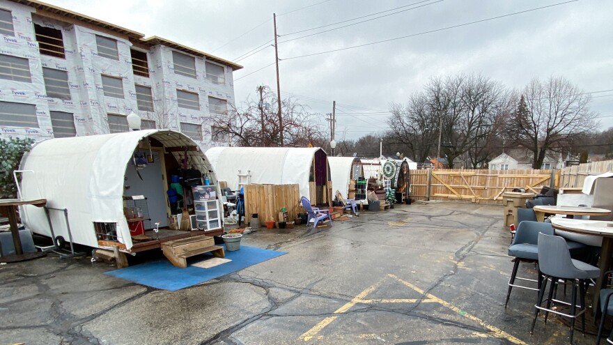 Conestoga huts house 22 formerly homeless people at this tiny home village in Madison, Wisconsin, located at the site of a shuttered bar.