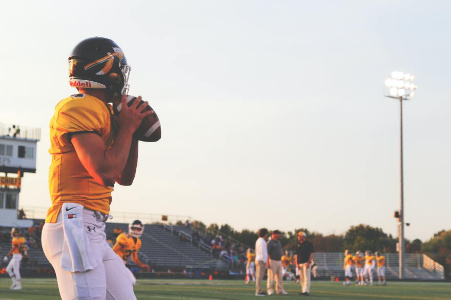 A football player with Kickapoo High School in Springfield, MO readies a throw.