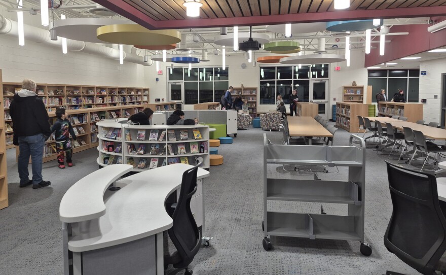 Students and their parents tour the Western Elementary School library during an open house for first and fourth graders.