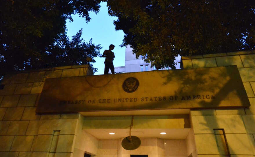 An Egyptian protester stands above the entry of the U.S. Embassy in Cairo on Sept. 11, 2012, during a demonstration against a film deemed offensive to Islam.