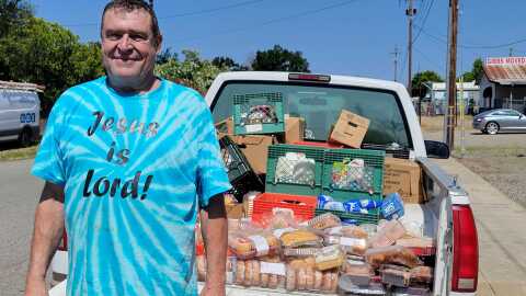Randy Dueck stands beside his truck filled with food to be delivered in Red Bluff, Calif. on May 17, 2024.