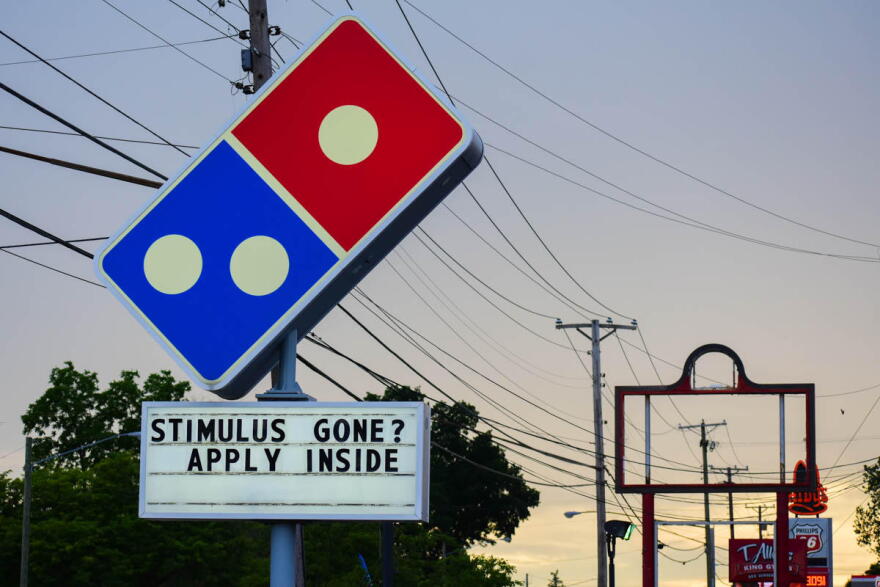 A Domino's Pizza in South Bend tells workers to apply if they're run out of pandemic stimulus money.