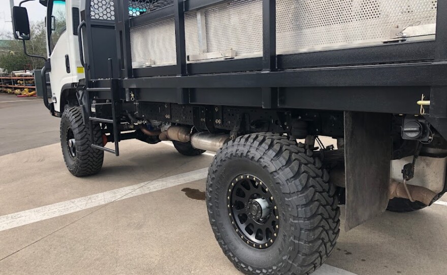 Side view of the CORE vehicle, showing its tires and high suspension.