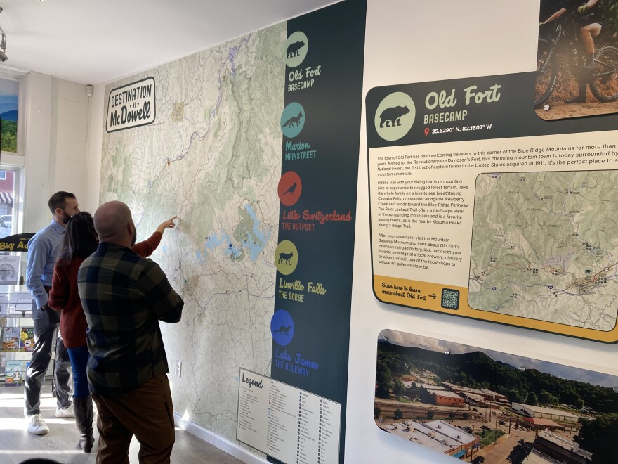 Residents examine the new maps at the McDowell County visitor center on Thursday, Nov. 20, 2025.